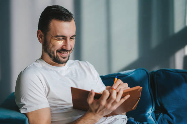 Man reviewing a paper checklist at a kitchen table
